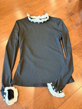 Black Long-Sleeve Top with White Ruffle Trim and Pearl Buttons